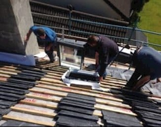 Image of men working on roof from AluPro Roofing in Cork.