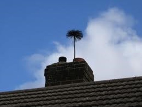 Image of chimney sweep brush coming out of chimney from Allclean Chimey Sweeps in Tallaght.
