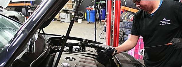 Image of mechanc working on car in Fair Deal Tyres in Naas.